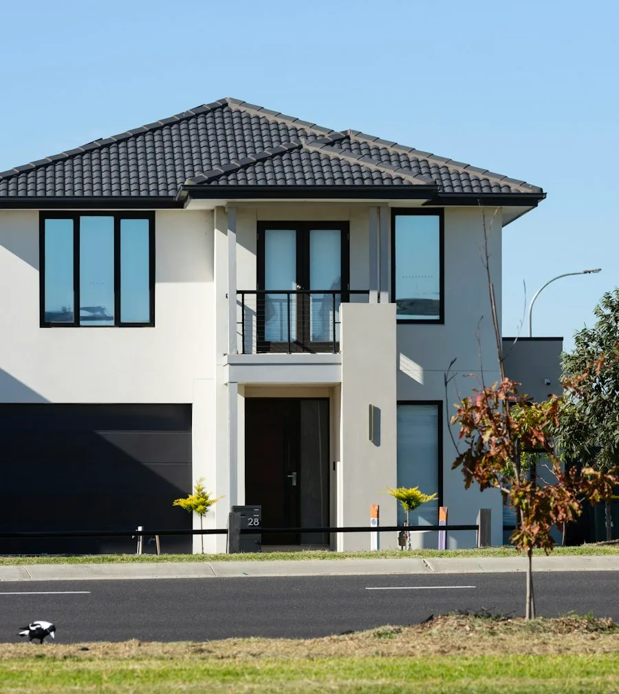 New construction two-story home with a dark sectional overhead garage door